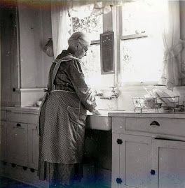 Grandmother in Apron Washing Dishes
